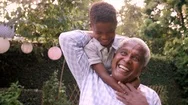 Young Black Boy Playing With Grandad In The Garden, Close Up Stock Footage