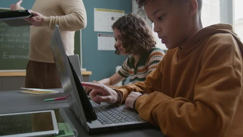 Young Black Boy Working with AI Generative Program on Tablet at Lesson Stock Footage 318719353