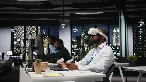 Young black businessman using virtual reality headset and other devices Stock Photos