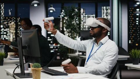 Young black businessman using virtual reality headset and other devices Stock Photos