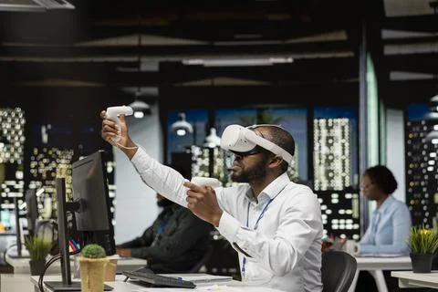 Young black businessman using virtual reality headset and other devices Stock Photos