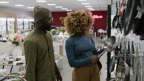 Young Black Couple Checking out New Frying Pan in Kitchenware Store Stock Footage 321773508