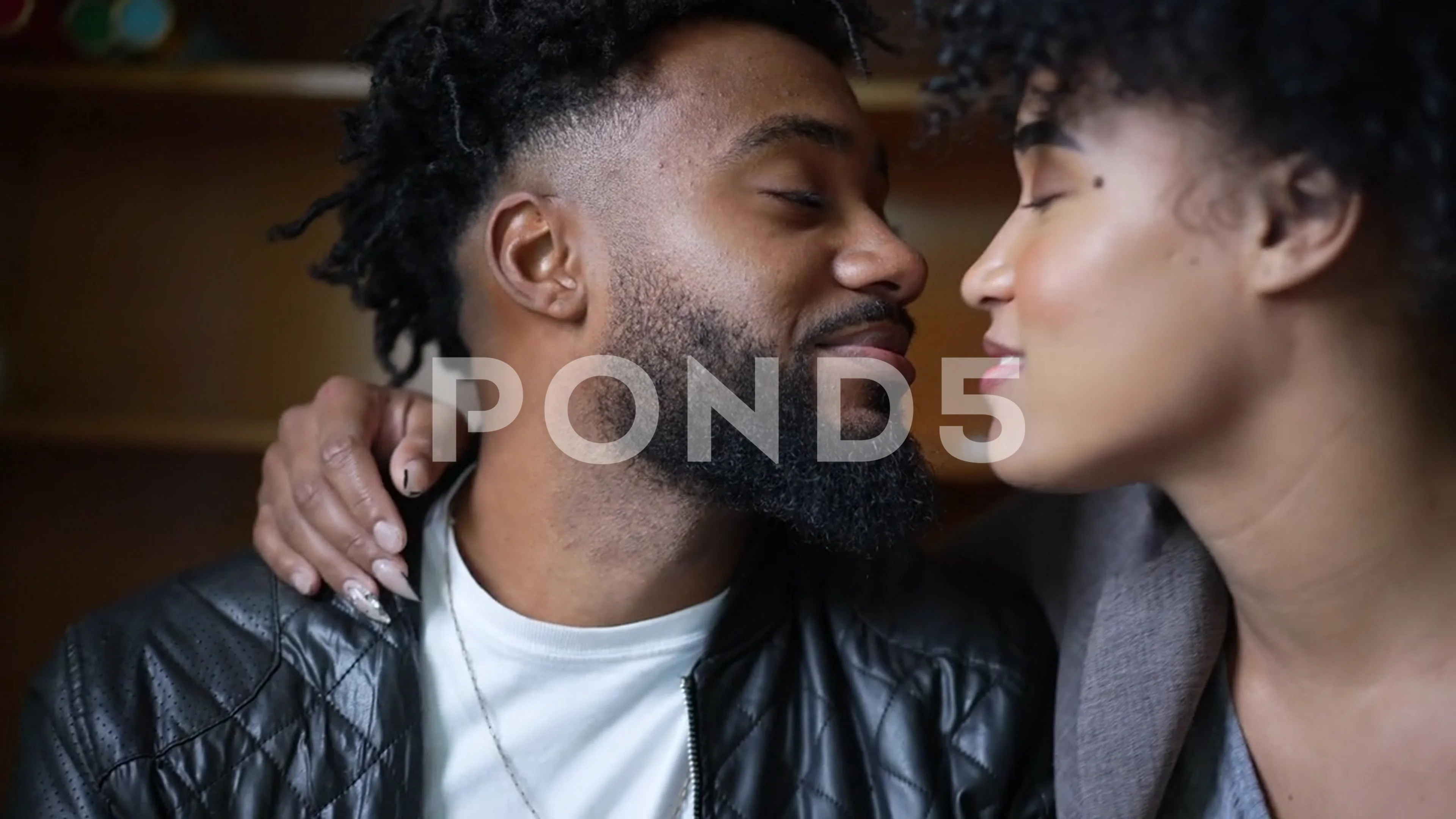 A young black couple kissing passionately