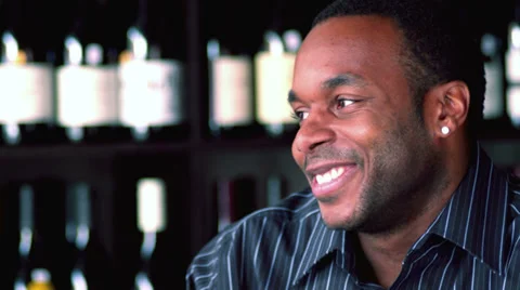 A young black couple sit at a bar and laugh and talk with each other Stock Footage 33993009