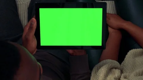 Young black couple work on tablet in living room - shot from above - closeup Video stock 82227449