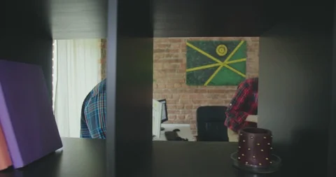 Young black creative bearded hipster takes blueprint or documents and walks Stock Footage 112533541