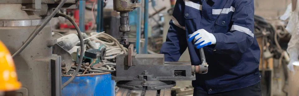 Young black engineer man operating lathe machine for preparing production a.. Фото
