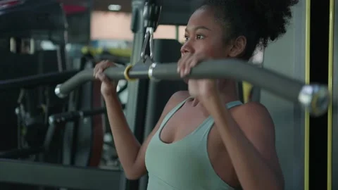 Young black female doing exercises fitness training chest muscles on machine  Video stock 219260204