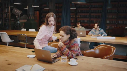 Young Black female worker solve problem with help of colleague Stock-Footage 178276124