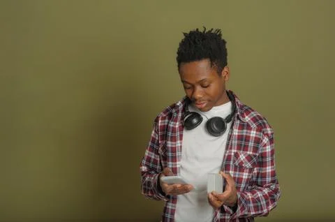 Young black guy connects bluetooth speaker to phone Stock Photos