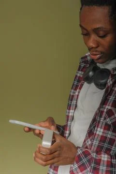 Young black guy connects bluetooth speaker to phone Stock Photos