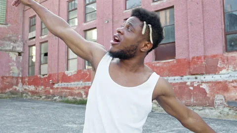 Young Black Guy Dancing On The Street. He Has Stylish Hairstyle. Behind The Guys Stock Footage 142021107