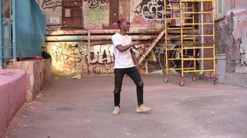 A young black guy is dancing on the street in a bad neighborhood Stock Footage 156206527