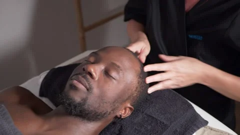 Young black guy gets face massage Stock Footage 225038439