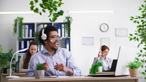 Young black guy having fun at work happy about good deal while working company Stock Footage 306145234