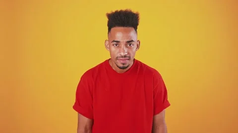 Young black guy looking at mirror, fixing his hairstyle and winking to himself Stock Footage 137979369