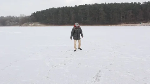 Young black guy slides on the ice near the forest Video stock 85660665