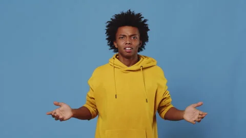 Young black guy throwing up his hands in the sides and looking disappointed and Stock Footage 254897040