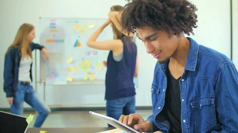 The young black guy thumbs through news on the Internet Stock Footage 60787538