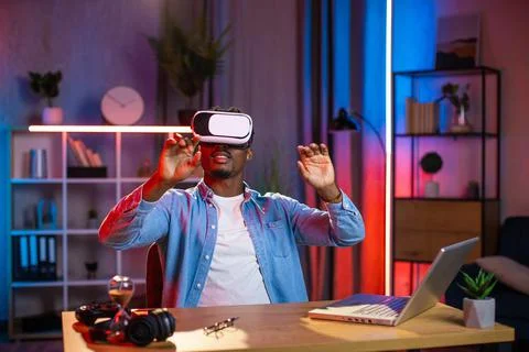 Young black guy in VR goggles working in augmented reality Stock Photos