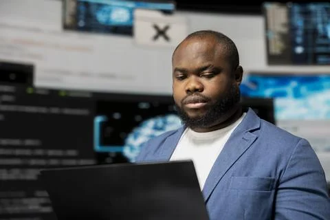 Young black IT engineer working in digital environment with programming language Stock-Fotos