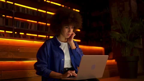 Young Black IT specialist working on laptop in hotel lobby, freelance job scene Stock Footage 312219897