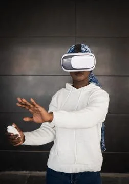 Young black lady exploring cyberspace in VR goggles Stock Photos