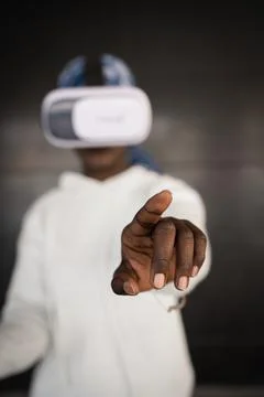Young black lady exploring cyberspace in VR goggles Stock Photos