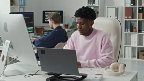 Young Black Male Developer Programming on Computer at Desk in IT Office Stock Footage 330128390