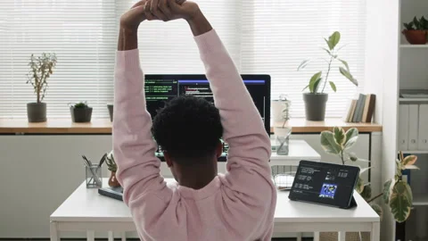 Young Black Male IT Developer Stretching Arms while Coding on Computer in Office Video stock 330125829