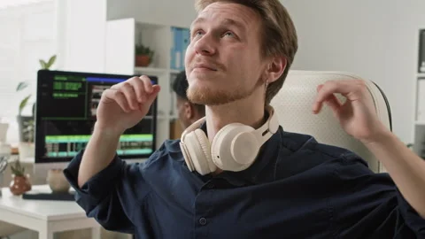 Young Black Male IT Developer Stretching Arms while Coding on Computer in Office 스톡 동영상 330125998