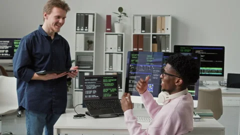 Young Black Male Lead Developer Talking to Smiling Junior Specialist in Office Video stock 330124654