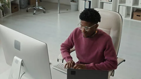 Young Black Male Programmer Typing Code on Computer at Office Workstation Stock Footage 330125090