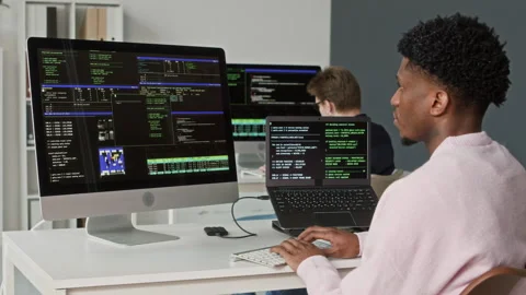Young Black Male Software Engineer Coding on Computer at Office Workstation Stock Footage 330129121