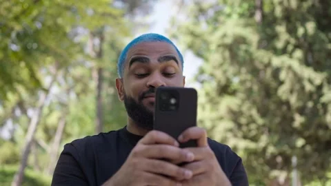 Young black man blue haired surprised expression looking 스톡 동영상 287491354