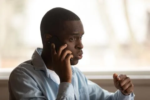 Young black man calling to support call center, problem solving. Stock Photos