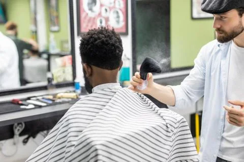 Young black man client getting new haircut in barbershop. Barber hairdresser  Stock Photos