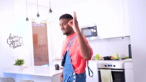 Young black man dancing urban style in kitchen Stock Footage 303152884