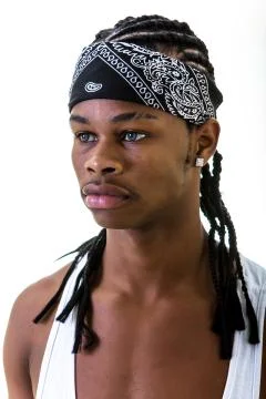 Young black man in do-rag looking away Stock Photos