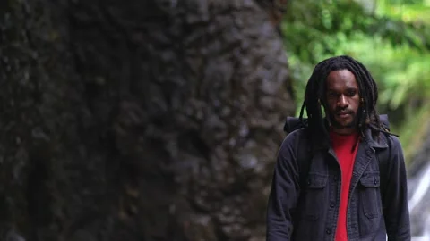 Young Black Man With Dreadlocks Walking While Looking Around Stock Footage 207674263