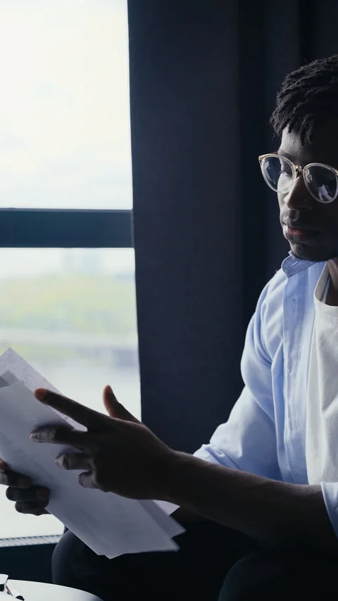 Young Black man finding mistake in company report, frustrated by business fail Stock Footage 307195801