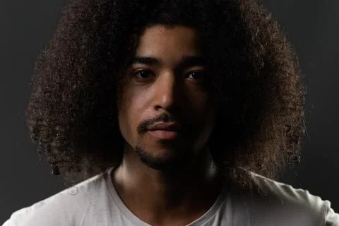 Young black man looking at camera with afro hairstyle Stock Photos