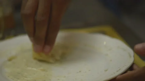 Young black man mop up one's plate with white bread 動画素材 64517971