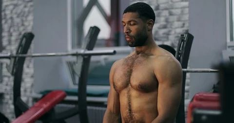 A young black man with muscles is preparing for training. Stock Footage 101340787