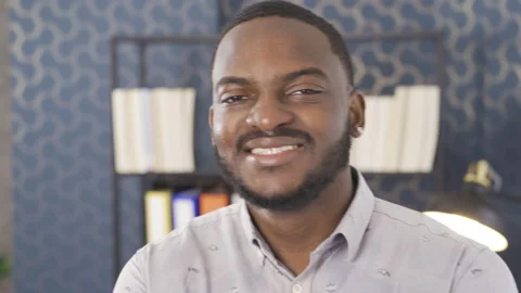 Young black man office worker. He is looking at the camera and laughing. Stock Footage 228805407