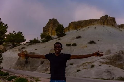Young black man posing in front of Frig ruins Stock Photos