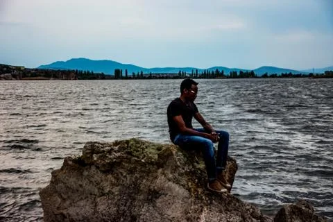 Young black man posing on the stone Stock Photos