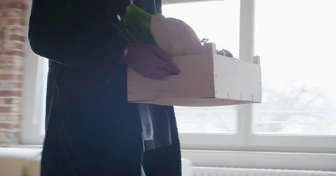 Young black man return home from shopping with grocery goods such as vegetables 動画素材 74217602