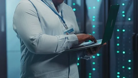Young black man server specialist using notebook checking hardware of Stock Footage 119782583