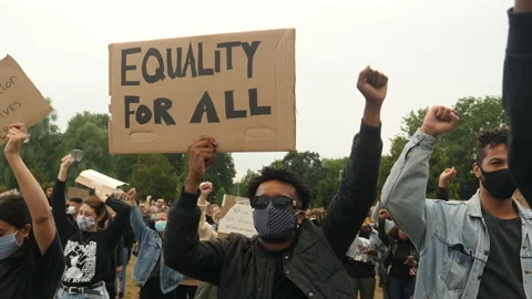 Young black man with sign 'Equality for All' at Black Lives Matter rally. Stock Footage